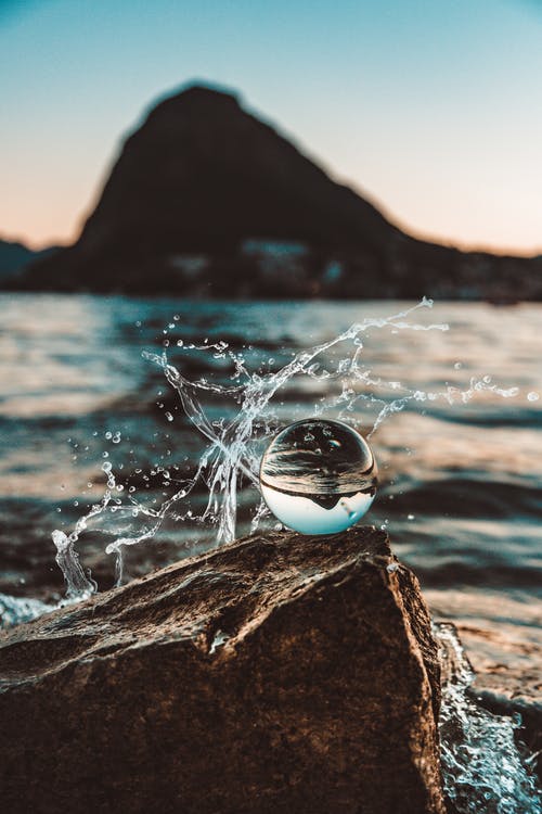 Drop of water splashing against rock