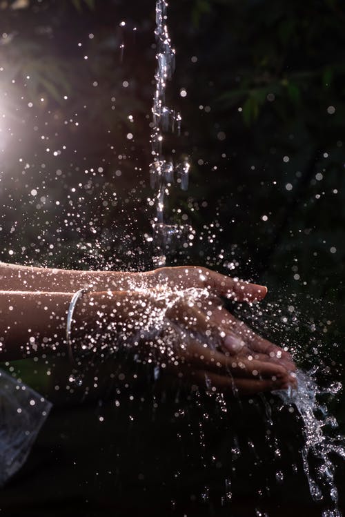 Hands receiving water